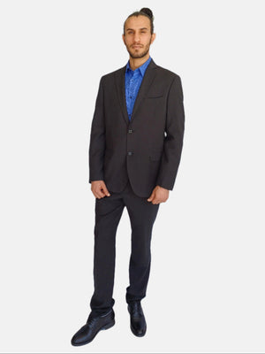 Man wearing a dark suit and blue shirt on a white background